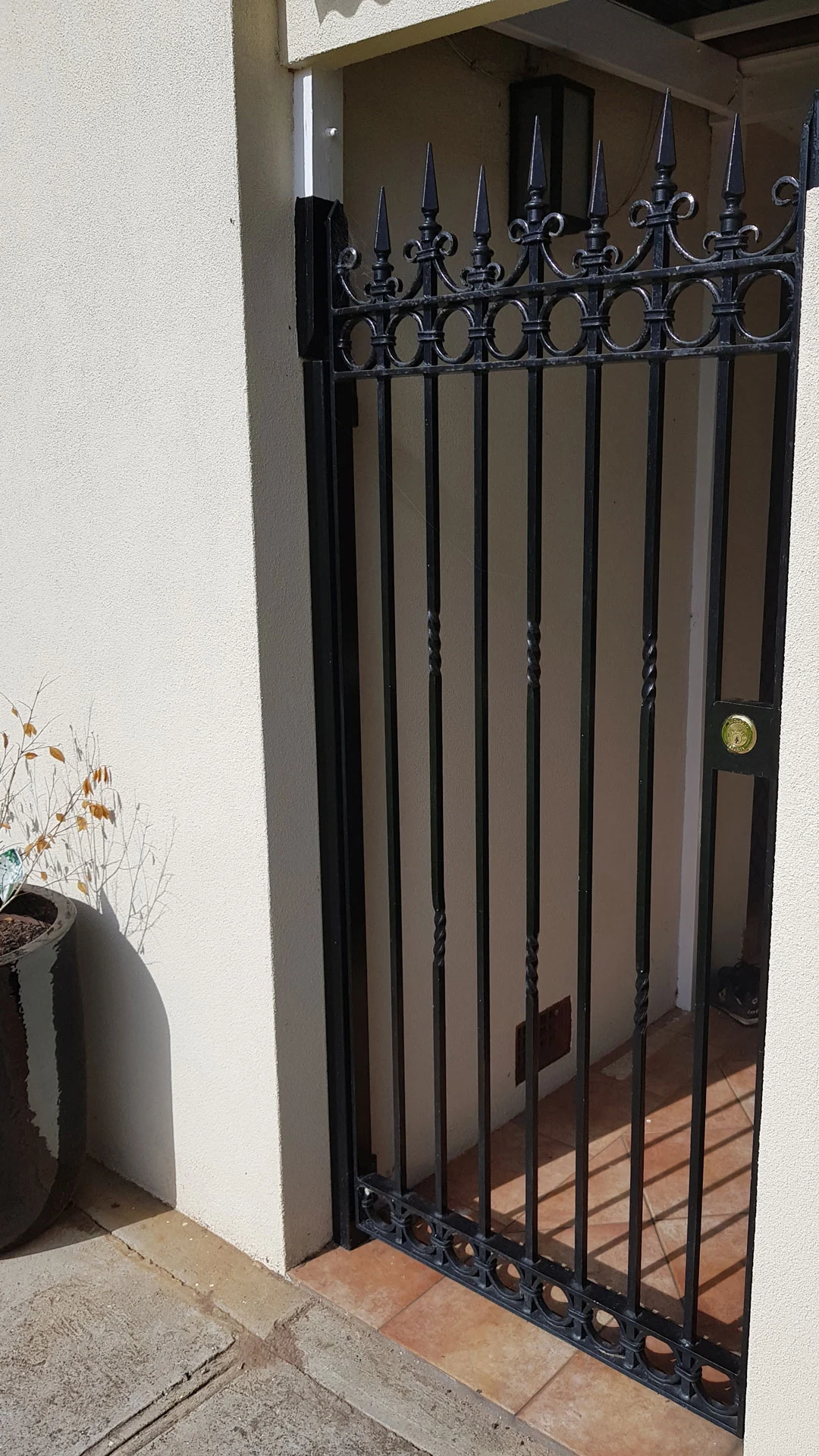 Black vertical-bar security gate at a home entrance