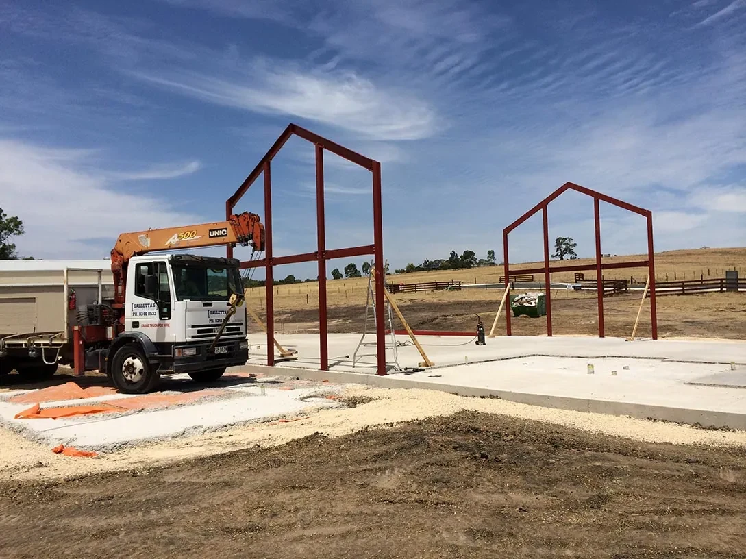 Galletta's crane truck beside structural steel frames erected on site