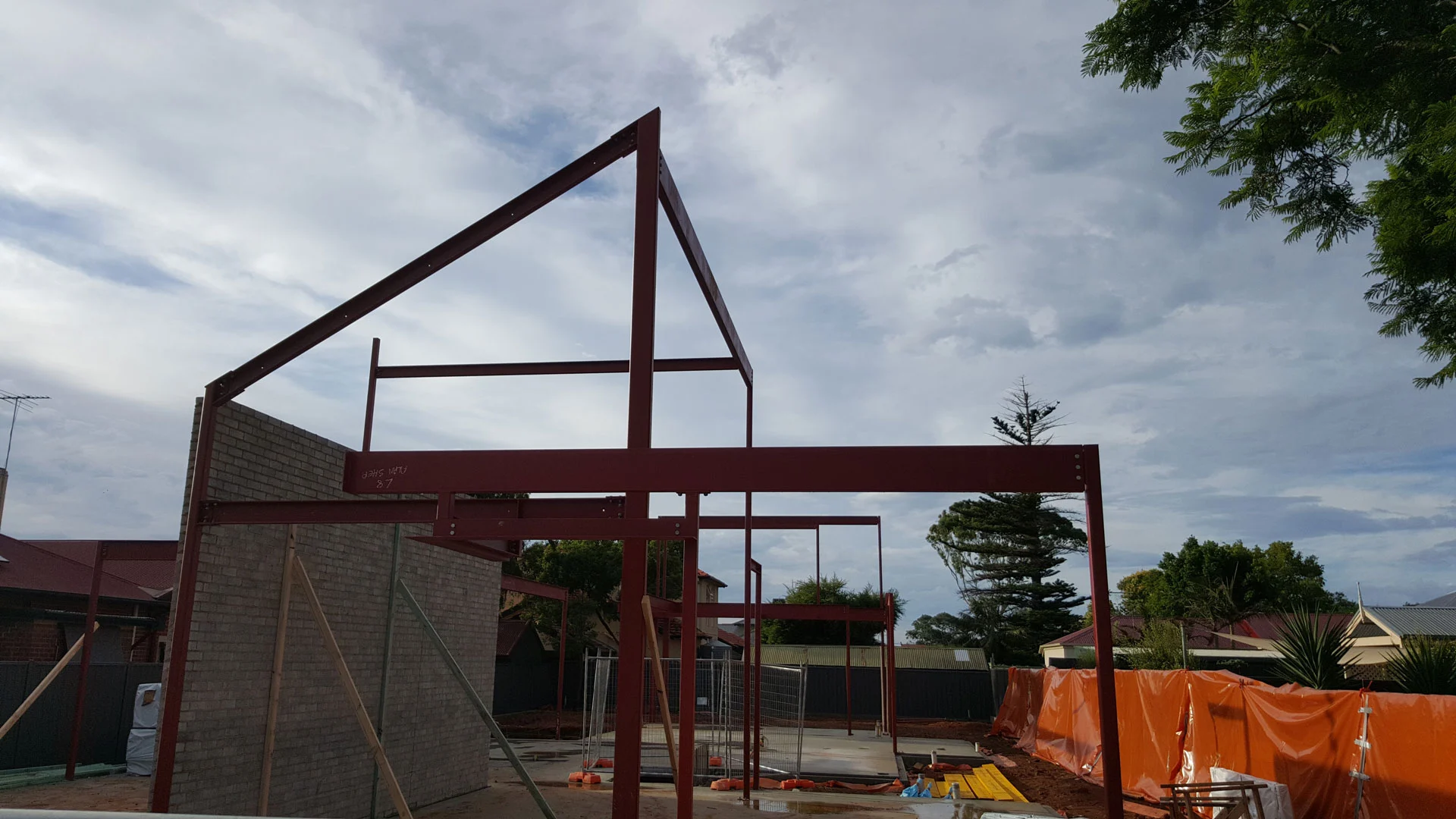 Red portal frame at a residential building site