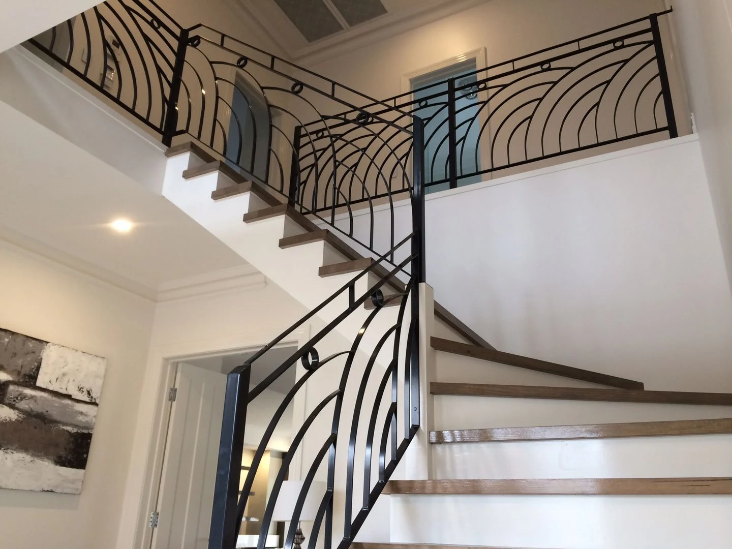 Curved decorative wrought iron balustrade fitted to an internal staircase