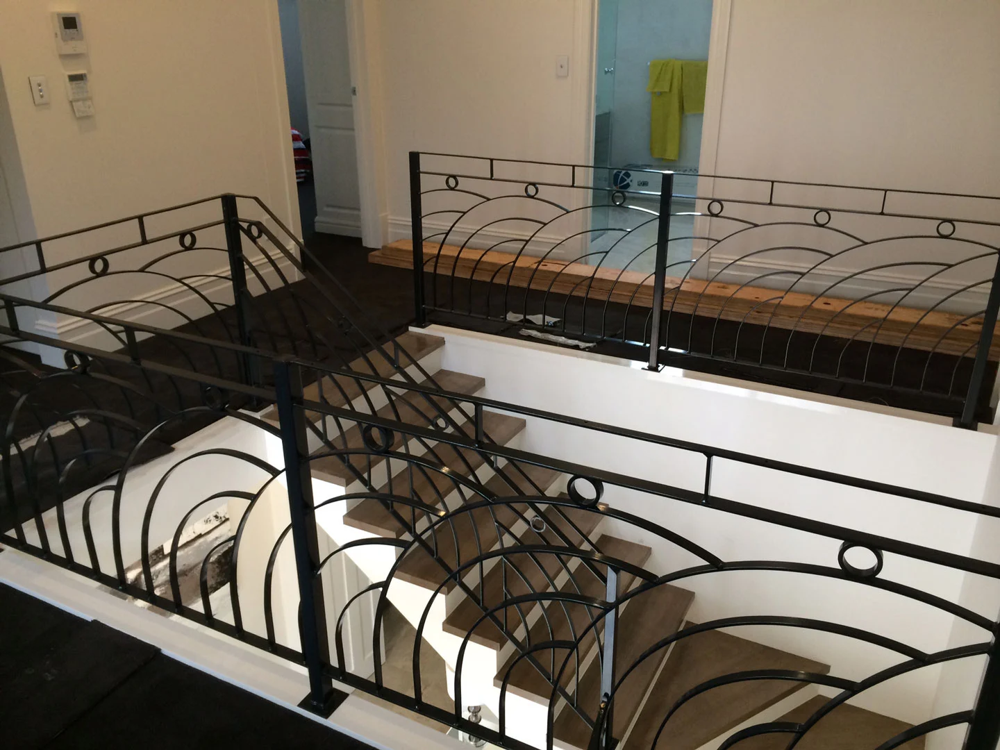 Curved wrought iron balustrade with circular scrollwork
