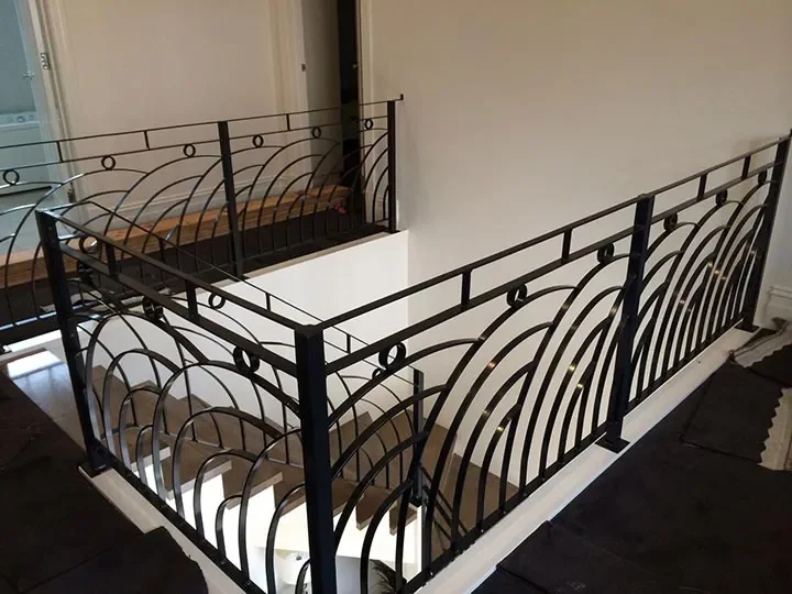 Custom black wrought iron balustrade surrounding an internal stairwell