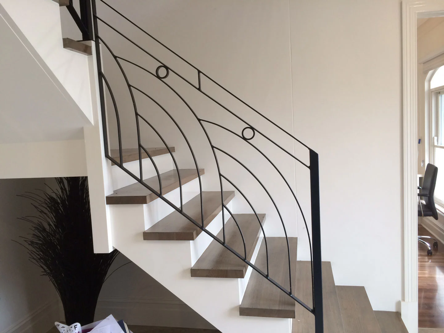 Modern curved wrought iron staircase railing