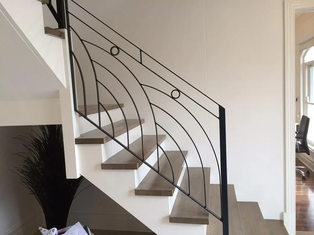 Custom black wrought iron balustrade installed beside a staircase