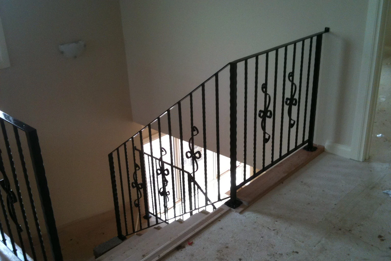Black wrought iron balustrade overlooking a stairwell