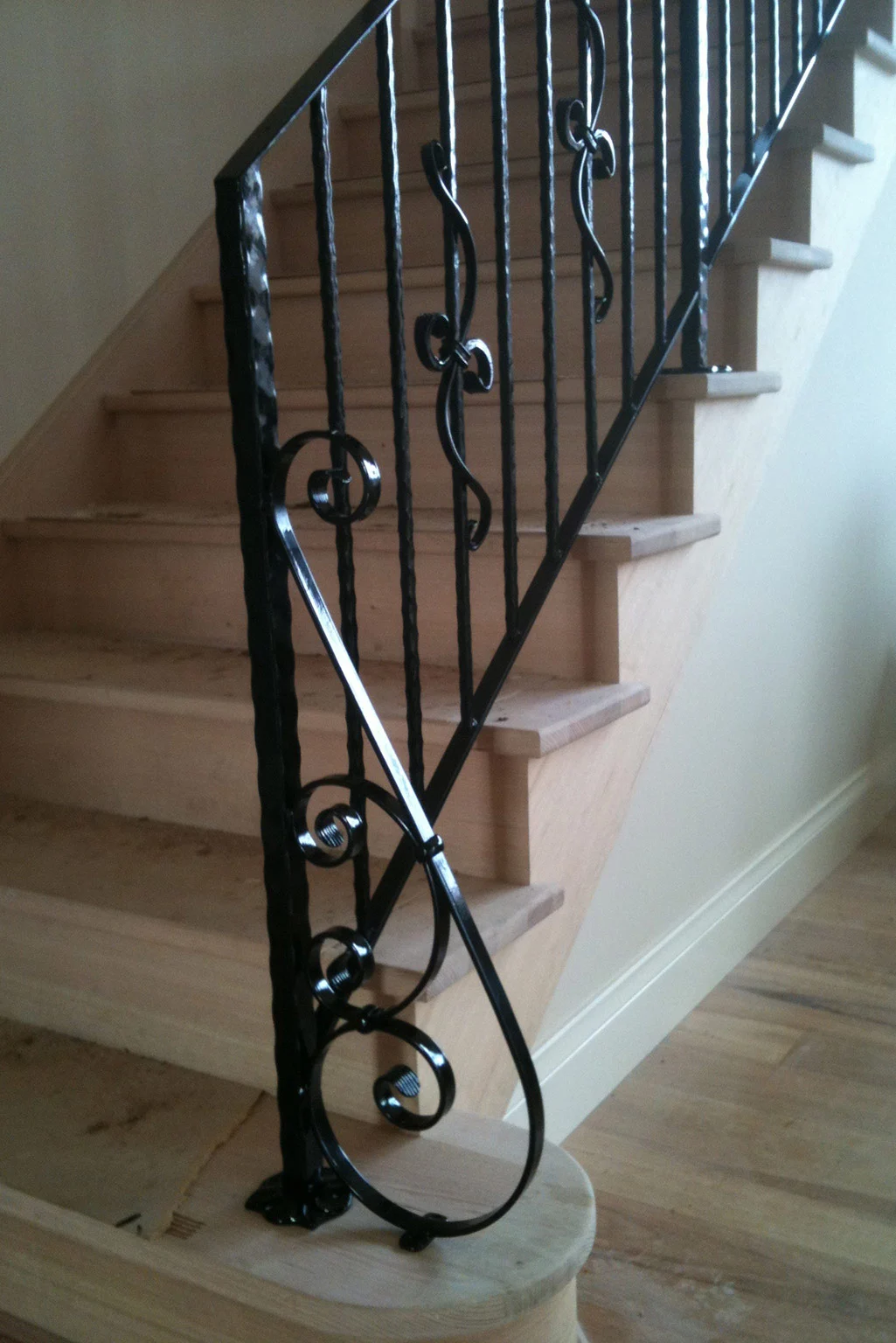 Decorative wrought iron railing on a timber staircase